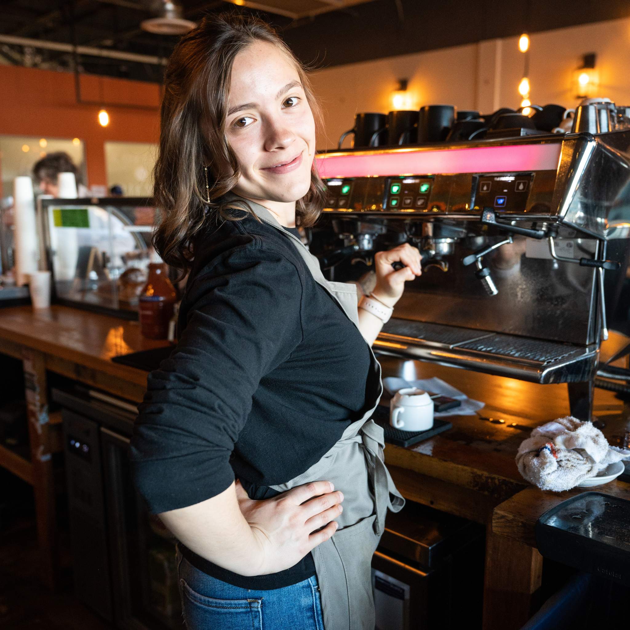 Barista at the coffee machine